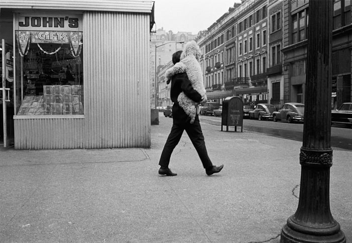 Man carrying toy in black and white photo by Joel Meyerowitz