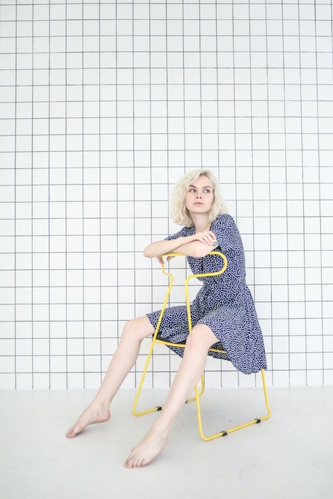 Woman sitting on a backwards chair as an idea for model poses
