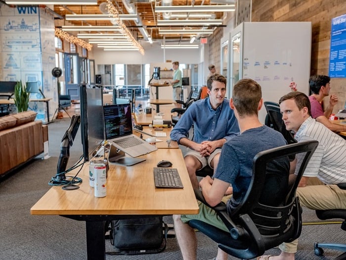 men having a meeting in an open office space