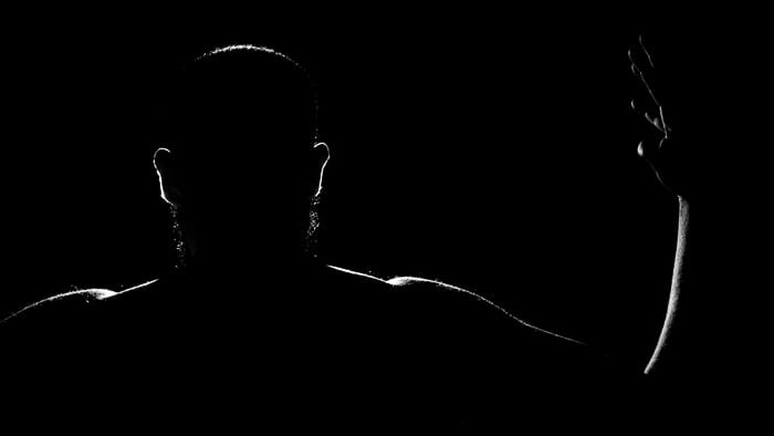 A low key portrait of a man using a rim light for portrait photography