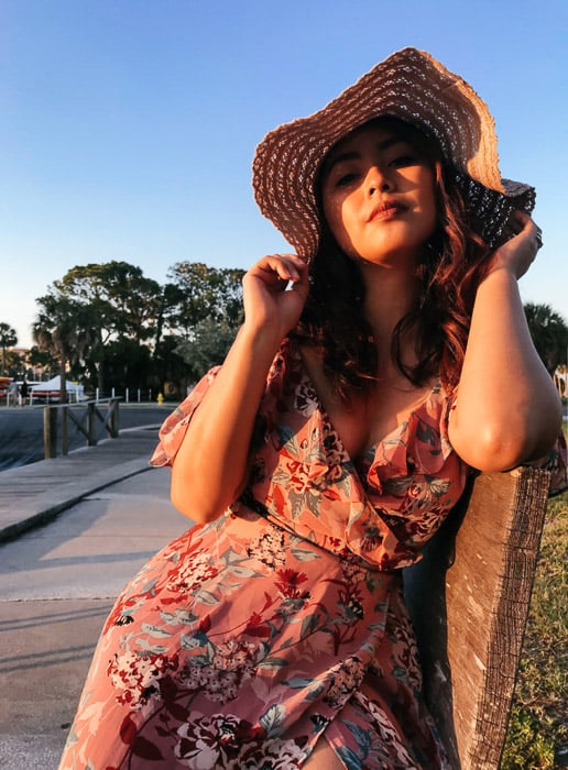  Girl in pink flowery dress and straw hat posing for the camera, outdoors on a bright day - Smartphone fashion photography shoot