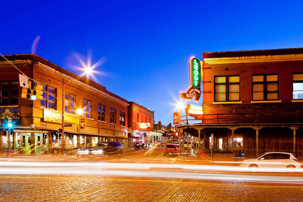 A town street with buildings light trails from traffic and a starburst effect from lights for creative lighting ideas