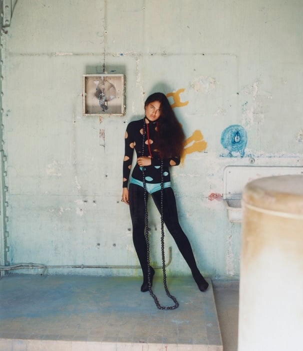 Woman posing in the back of a factory